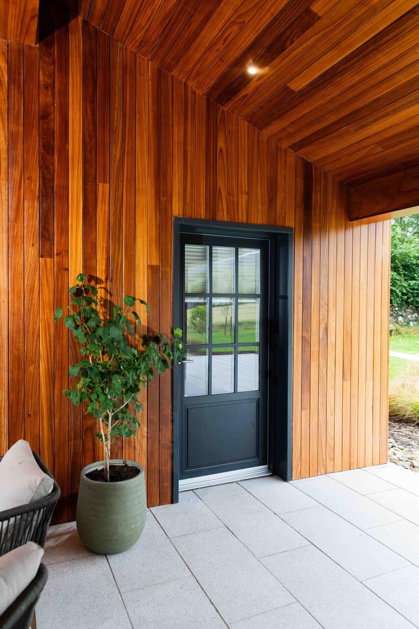 The cedar-clad entrance porch of The Chocolate Lodge, looking through to the Burren fields